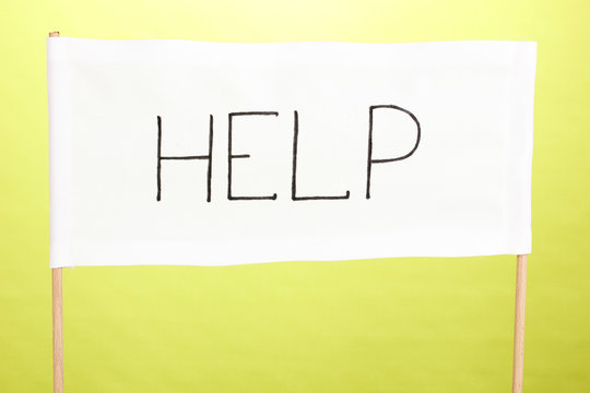 Fototapeta Help written on white cloth on green background
