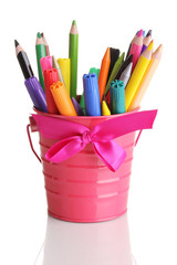 Colorful pencils and felt-tip pens in pink pail isolated