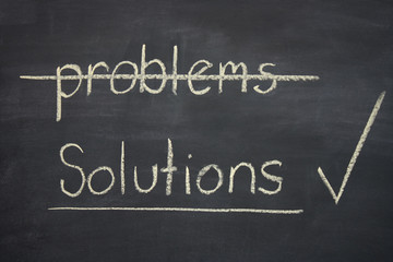 problems - solutions written on a blackboard with solutions tick