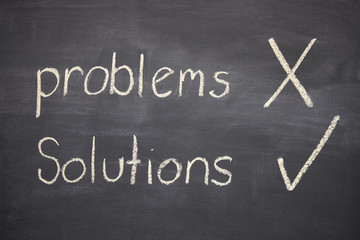 problems and solutions written on a blackboard