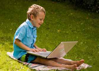 young boy using his laptop