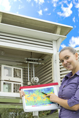 Smiling young woman meteorologist