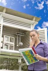 Young woman meteorologist reading meteo instruments