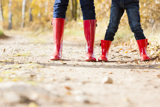 detail of mother and daughter wearing rubber boots
