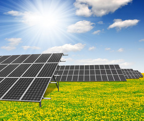 Solar energy panels against blue sky with clouds