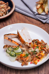 Fototapeta premium Chicken fillet with chanterelle mushrooms and baked potatoes