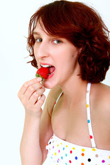 Young woman eating a strawberry