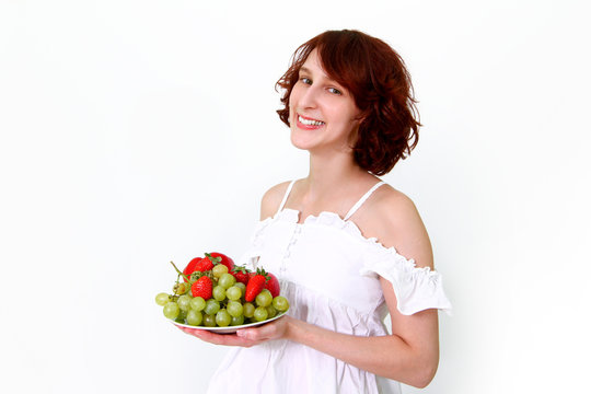 Young woman with fruits on a dish