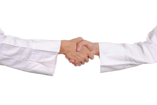 handshake by hands with shirts, isolated on white