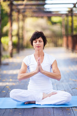 Fototapeta na wymiar middle aged woman yoga meditation