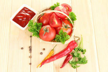 Still life tomatoes ketchup and herbs on wooden table