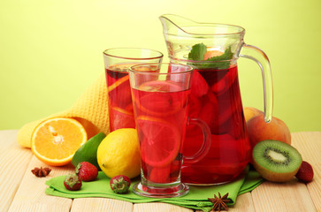 sangria in jar and glasses with fruits,