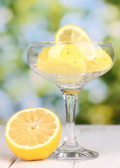 delicious ice cream on wooden table on bright background