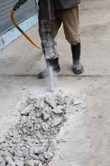 worker man drilling cement concrete ground