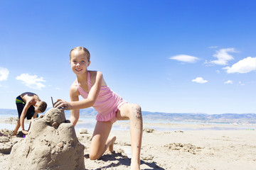 Girl Building a Sand Castle at the Beach