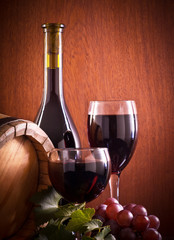 Naklejki  Kieliszek do czerwonego wina i butelka na drewnianym tle