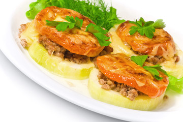 Backed vegetable marrow stuffed with meat, tomato, cheese and gr