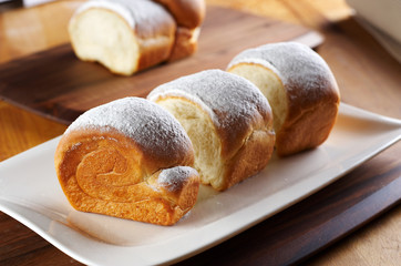 Rolled bread with sugar powder