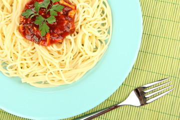 Italian spaghetti in plate on bamboo mat