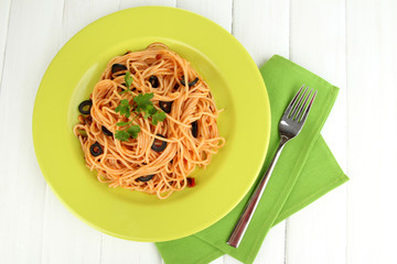 Italian spaghetti in plate on wooden table