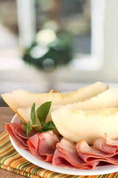 parma ham and melon, on wooden table