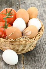 Fresh eggs and tomatoes in the basket