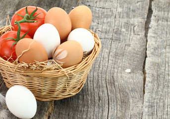 Fresh eggs and tomatoes in the basket