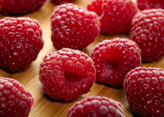 Raspberry fruit on wooden background