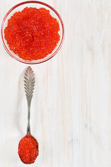 Red caviar in the glass jar and silver spoon