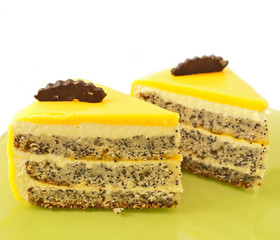 2 Slice of delicious mango cake with poppy on green plate