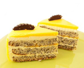 two  Slice of delicious mango cake with poppy on green plate