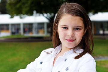 Portrait of beautiful girl posing outside