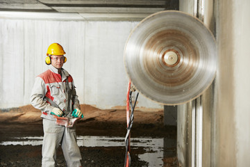 builder worker operating demolition machine