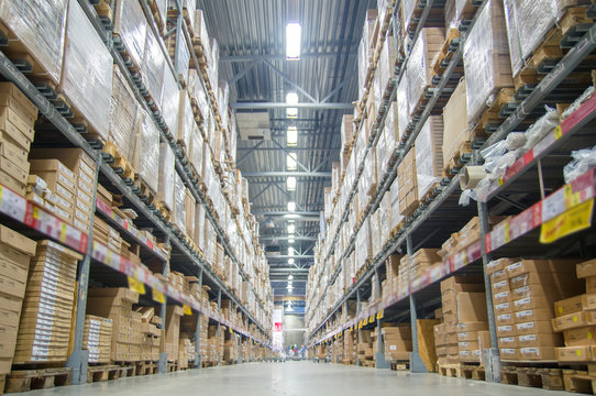 Rows of shelves with boxes in modern warehouse