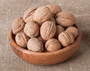 pile of walnuts in small wooden bowl