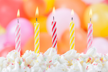 Five Birthday candles on colorful balloons background 