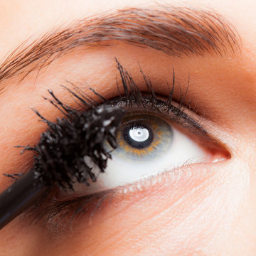 Woman applying mascara