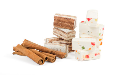 Sweets and cinnamon sticks isolated on white background