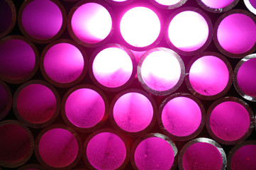 Steel pipes bundled together in a warehouse.