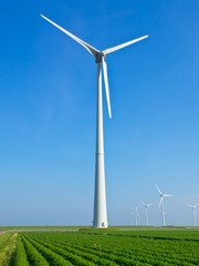 Giant wind turbine in dutch agricultural landscape