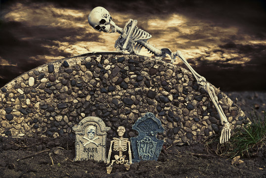skeleton on cemetery wall