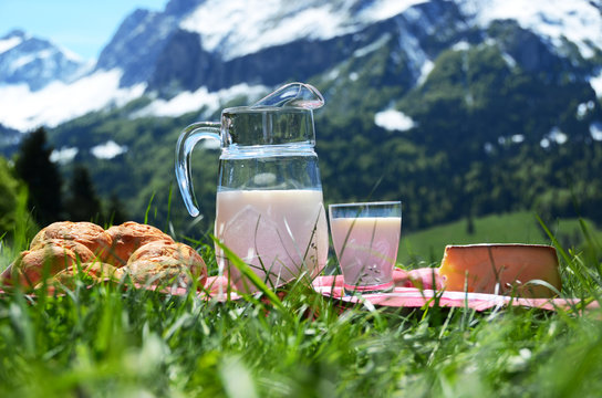 Milk, cheese and bread served at a picnic. Switzerland