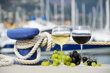Wineglasses and grapes on the yacht pier of La Spezia, Italy