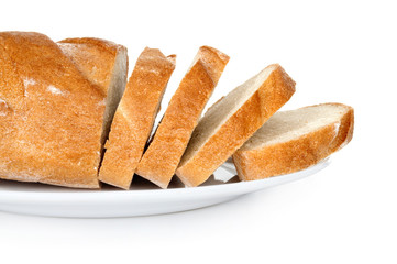 The cut loaf of bread on plate isolated on white