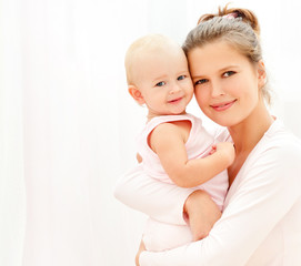 Mother and daughter play in the bedroom