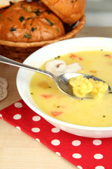 Fragrant soup in white plate on table close-up