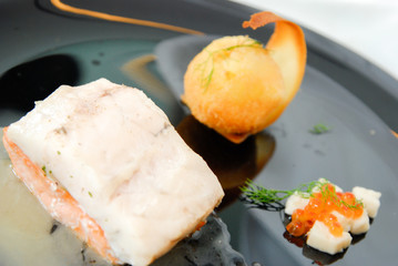 Salmon steak with sauce and fried potato