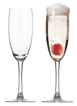 full and empty glass of champagne with strawberry