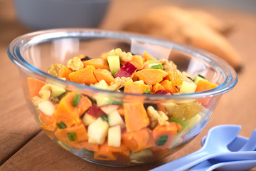 Salad made of sweet potato, apple, nut, raisin, shallot