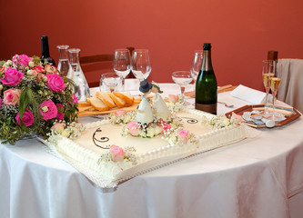 Table setting at a restaurant with wedding cake